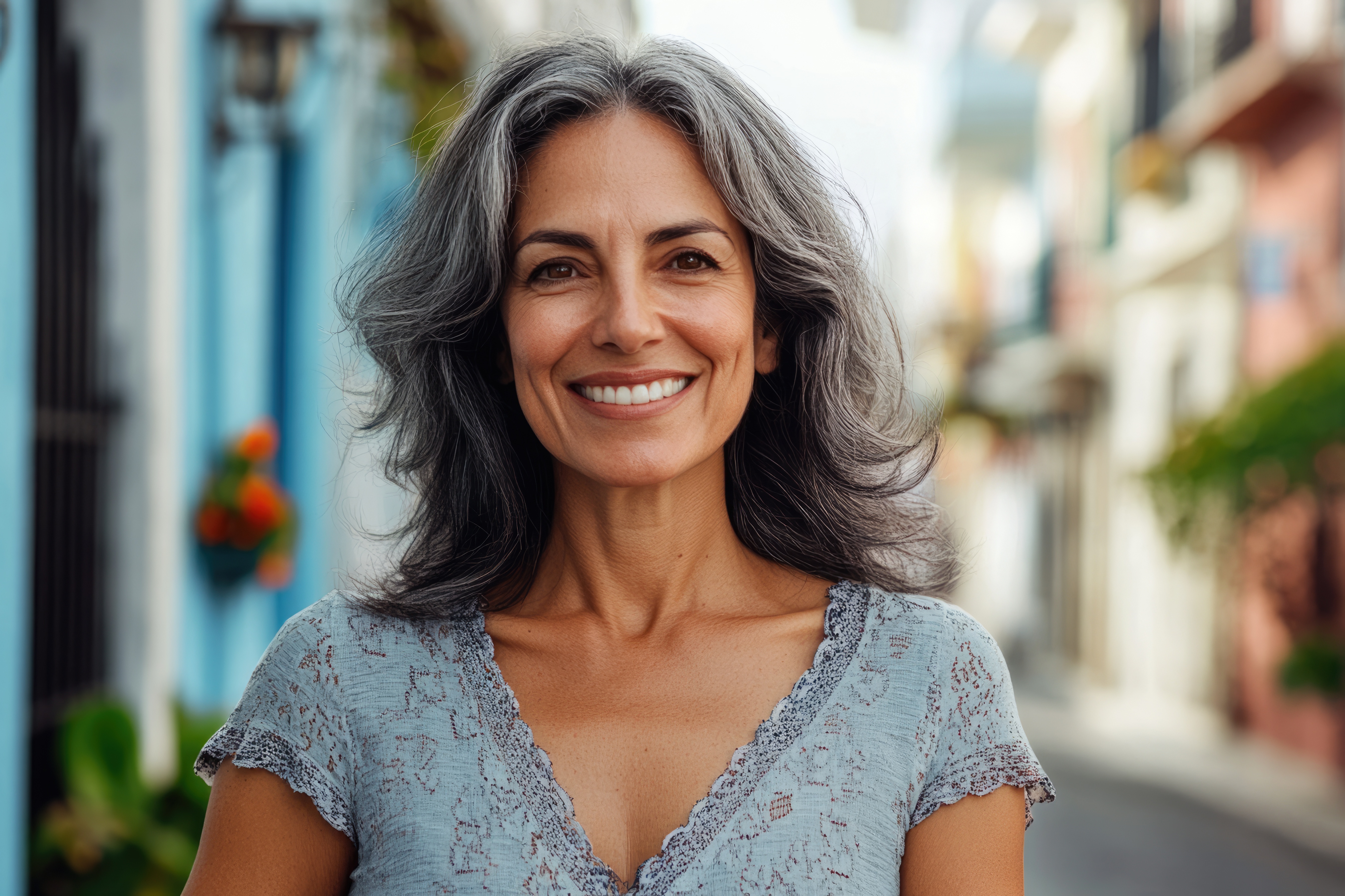Confident middle aged Hispanic woman smiling on street. Praxis Corrado Bad Homburg